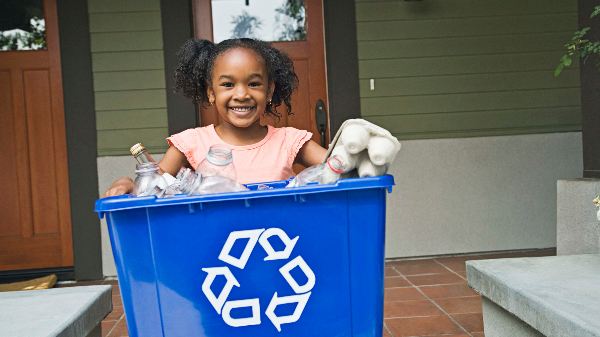 Girl with recycling bin