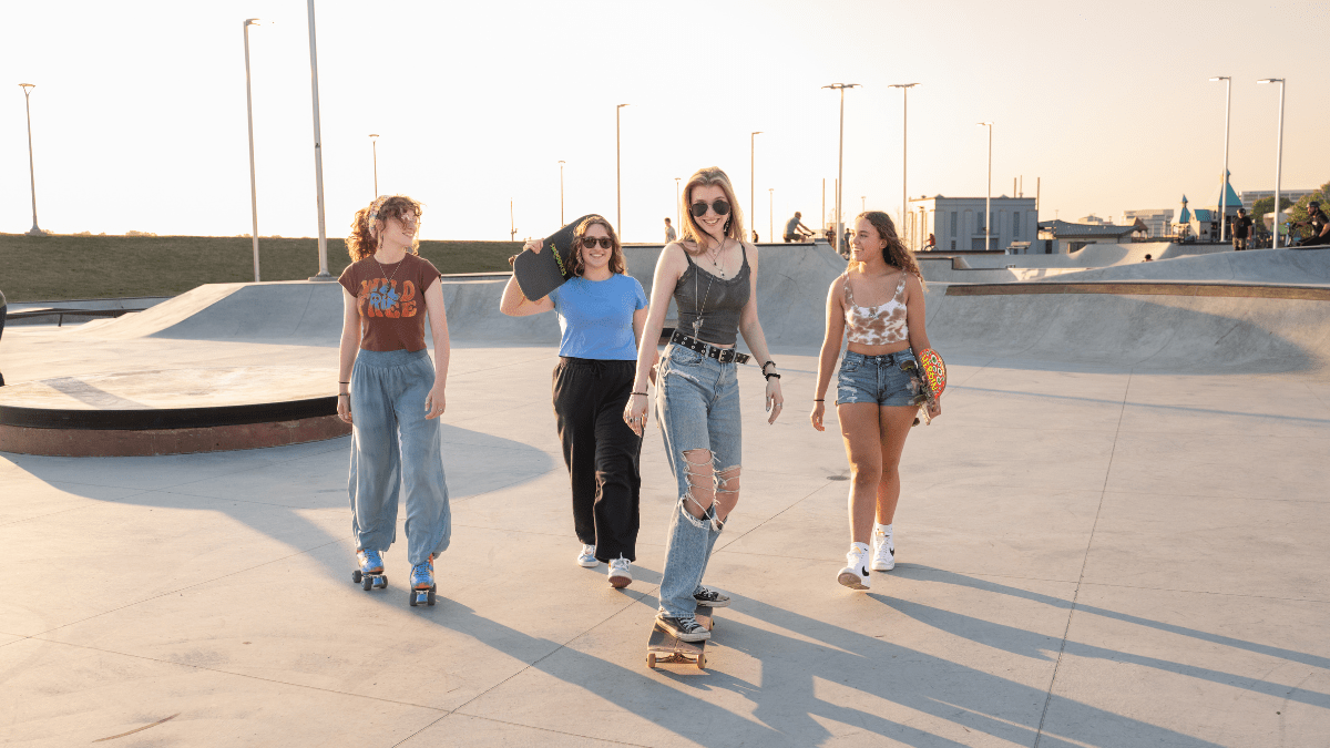 Young Women Skating at Sunset Skatepark 