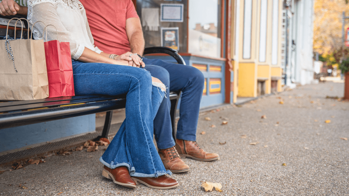 couple sitting outside thrift shop