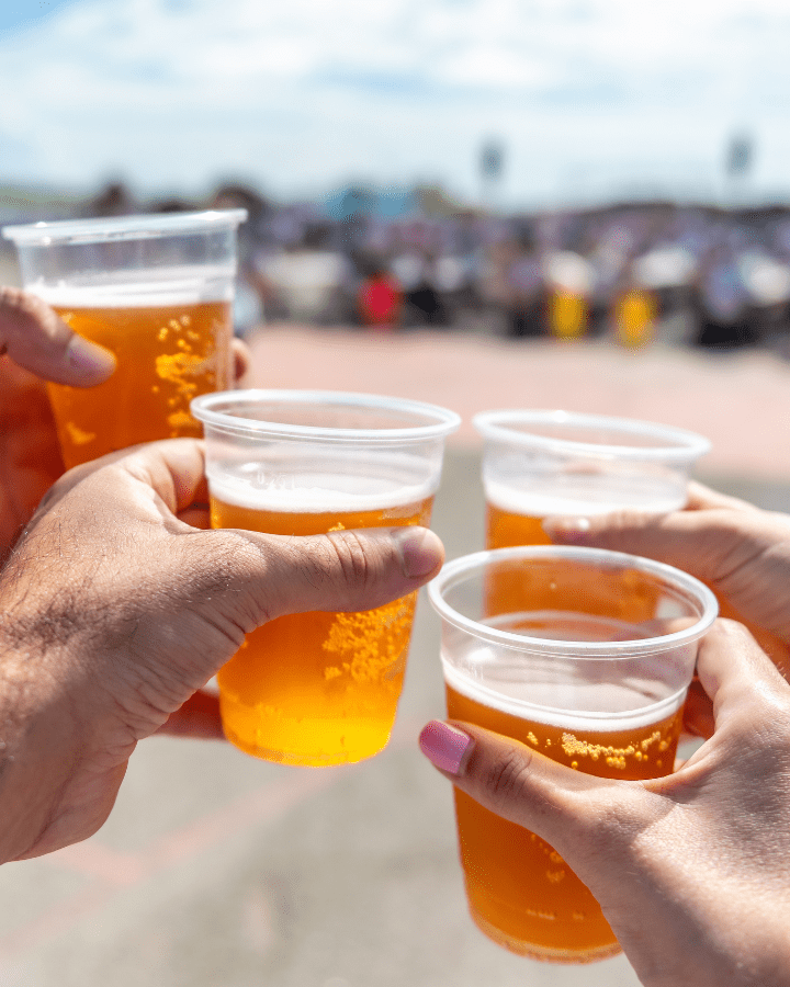 hands holding beers at swirca brewfest 