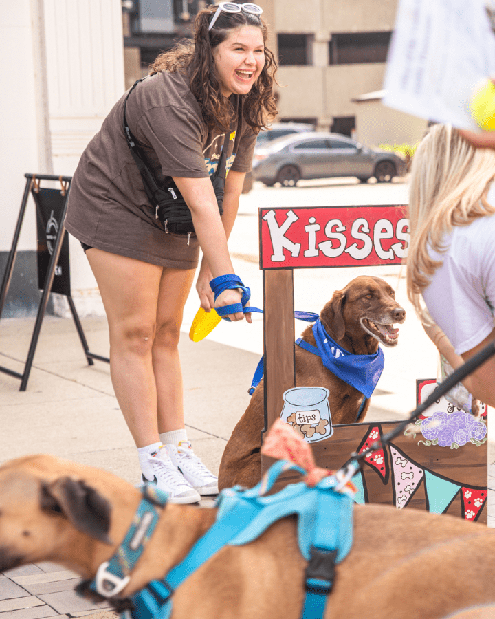 woman and dog posing at dog day downtown