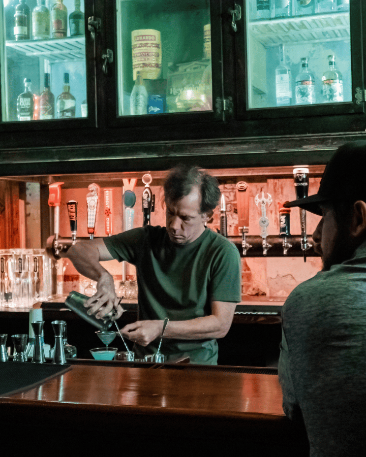 arcademie bartender pouring drink