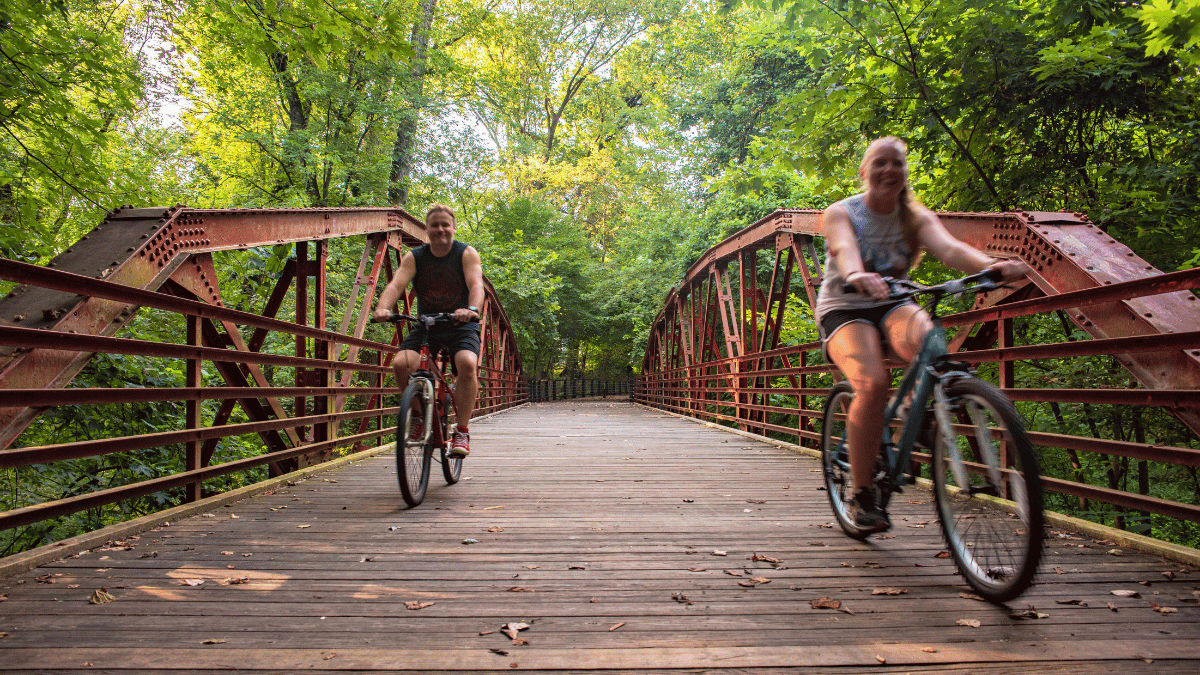 Two people enjoy outdoor exercise by bike in the Evansville Region